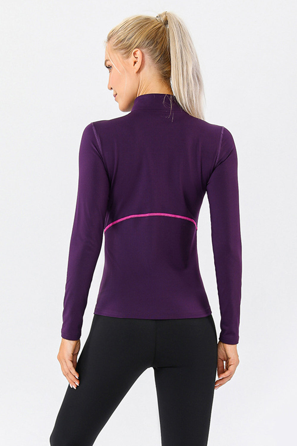 Violet athleisure zip-neck top with contrast pink seam detail and long sleeves.