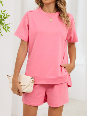 Pink relaxed two-piece set with crew neck tee and shorts, featuring pockets.