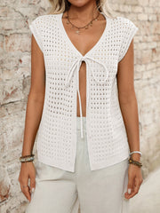 Open-knit sleeveless ivory cardigan with tie-front detail and V-neckline.
