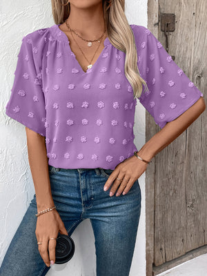 Heliotrope purple Swiss dot blouse with V-neck and short flutter sleeves.
