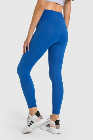 Sculpted high-waist performance leggings in blue, ankle-length, with a seamless back detail.