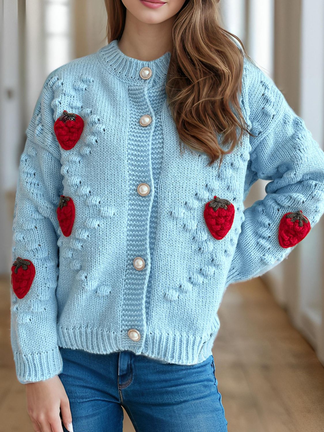Pastel blue knit cardigan with strawberry appliques and pearl buttons.