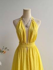 Yellow Swiss dot halter dress with deep V-neck and smocked waist.