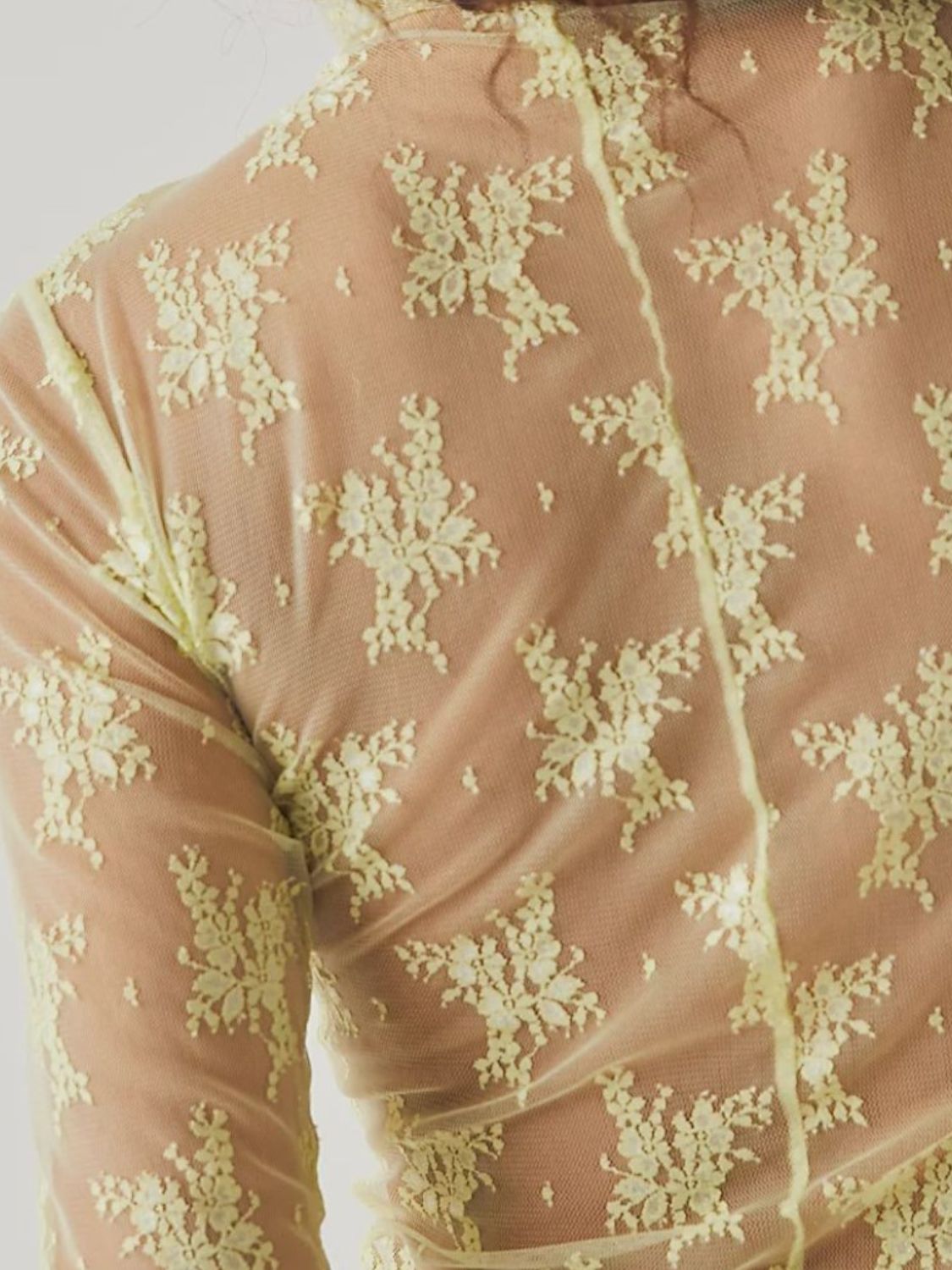 Floral lace illusion mock neck top in lime with long sleeves and a sheer mesh overlay.