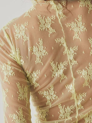 Floral lace illusion mock neck top in lime with long sleeves and a sheer mesh overlay.