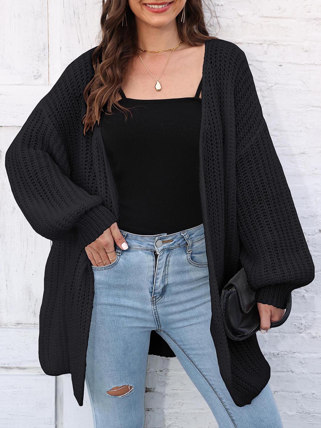 Black open knit cardigan with balloon sleeves and a relaxed fit.