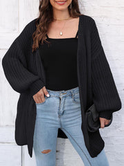 Black open knit cardigan with balloon sleeves and a relaxed fit.