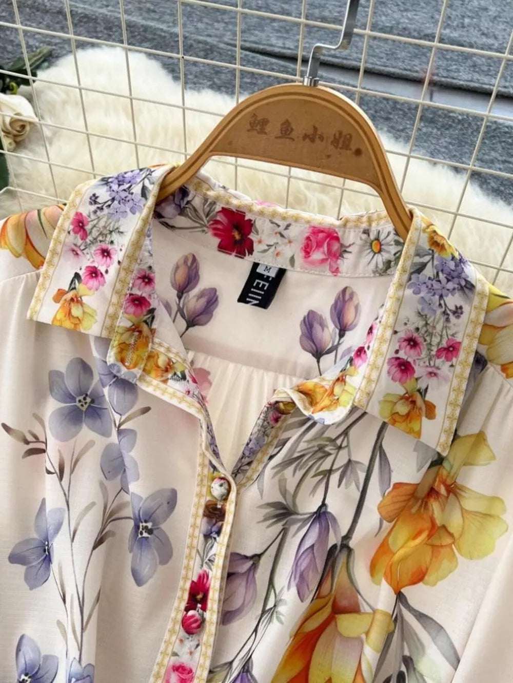 Vibrant floral midi dress with button front and lantern sleeves, featuring a colorful brocade print.