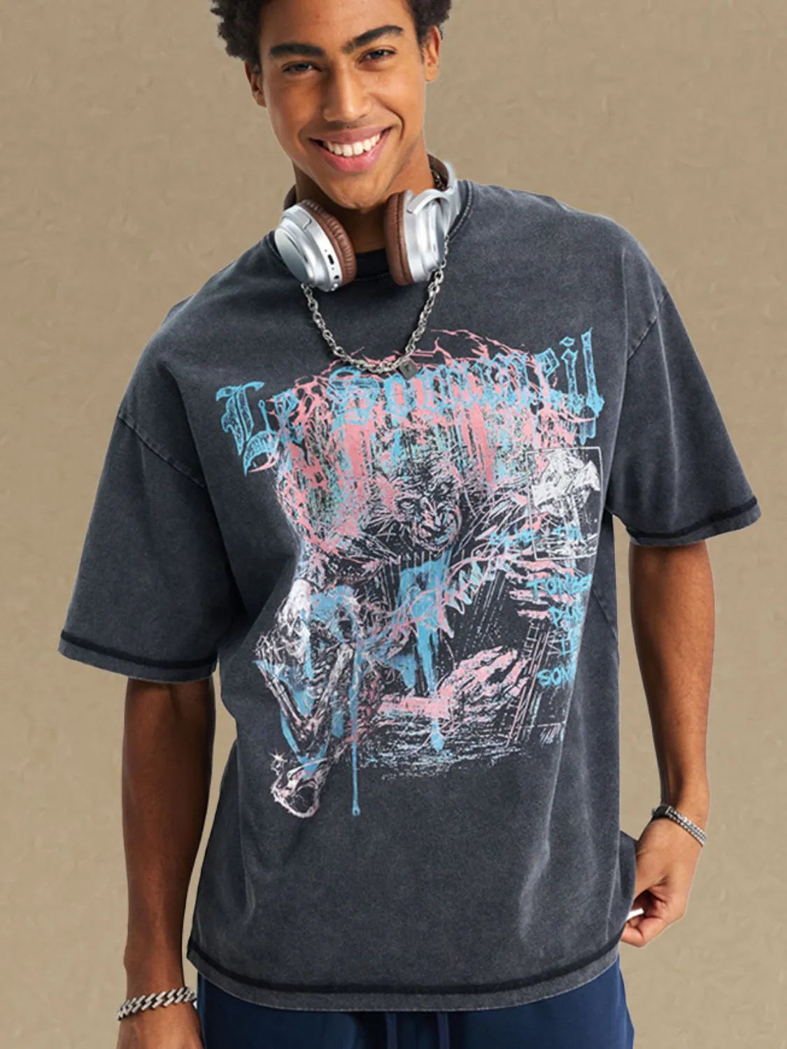 Black acid wash oversized graphic tee with distressed print and crew neck.
