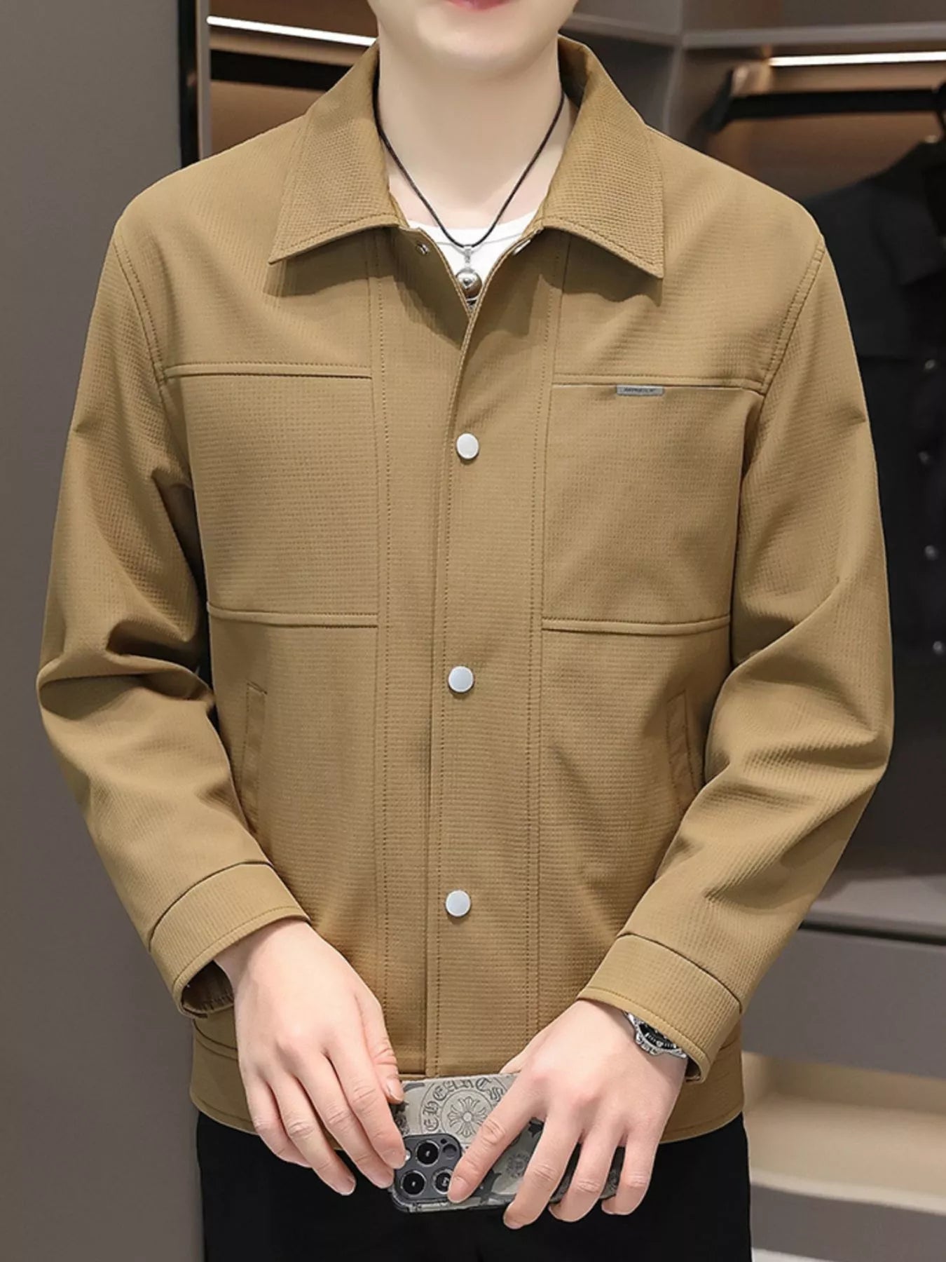 Men's caramel snap down jacket with textured fabric and chest pockets.