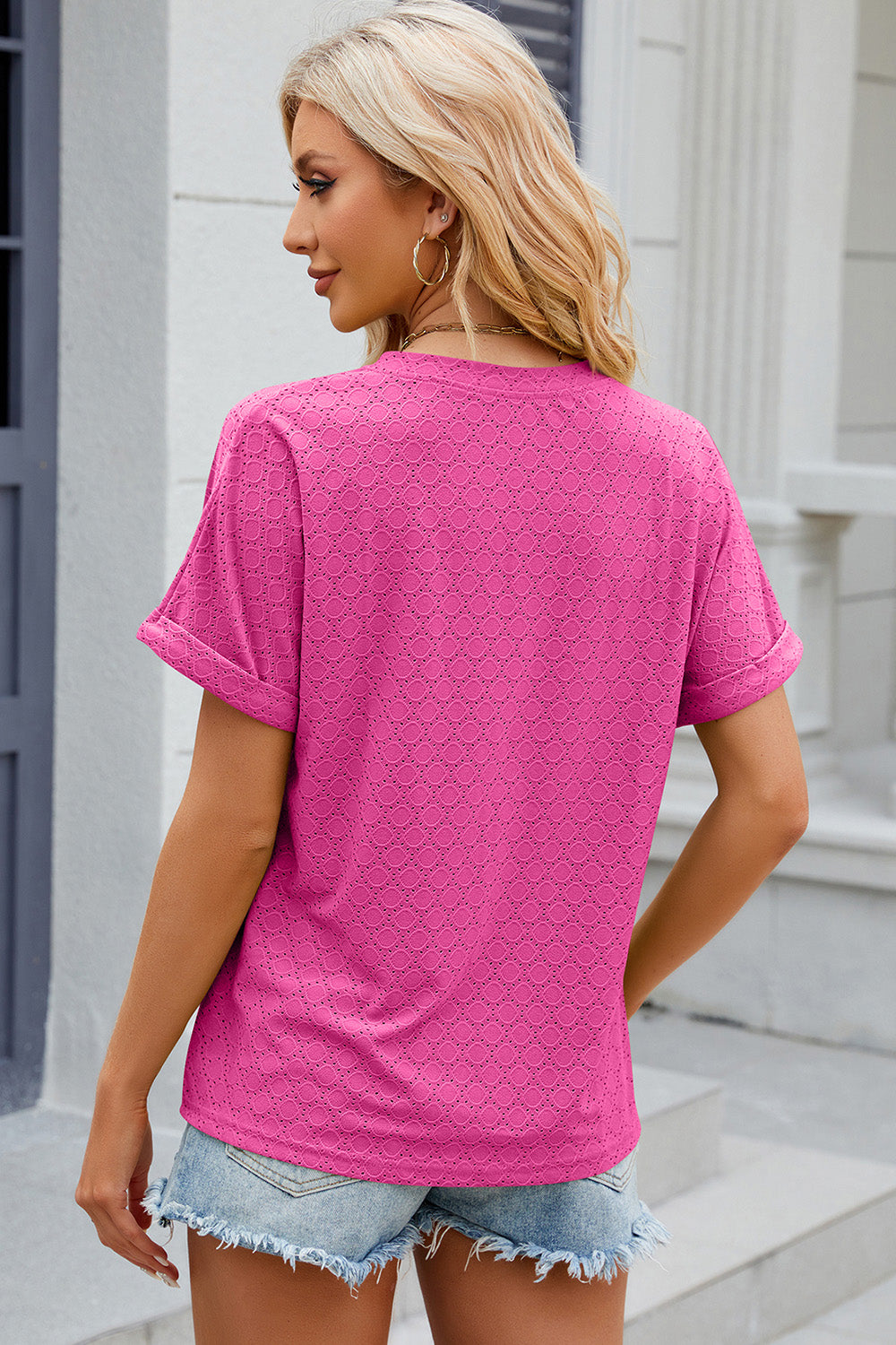 Textured hot pink henley tee with rolled sleeves and a geometric pattern.