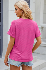 Textured hot pink henley tee with rolled sleeves and a geometric pattern.