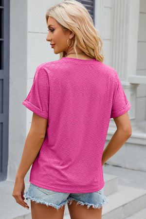 Textured hot pink henley tee with rolled sleeves and a geometric pattern.