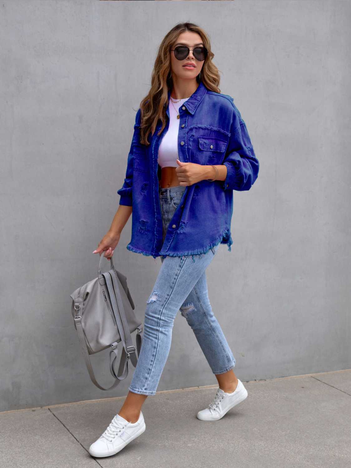 Royal blue distressed denim shacket with frayed hem and cuffs.