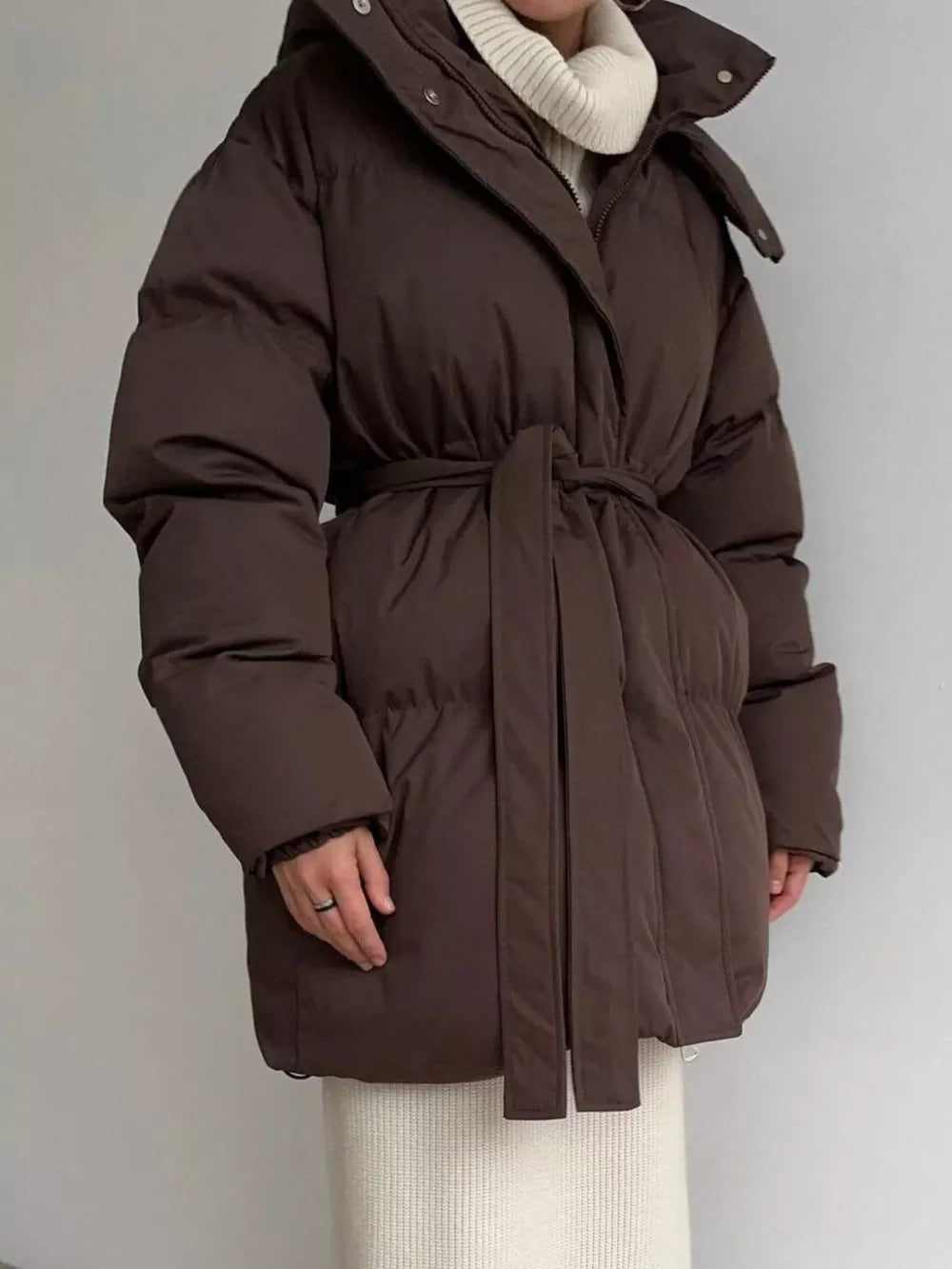 Dark brown belted puffer trench coat with hood and a tie waist.