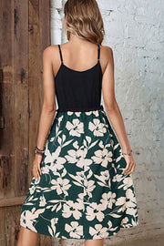 Camisole bodice midi dress in forest green with a cream floral print and ruffled hem.