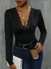 Black lace trim bodysuit with plunging neckline and long sleeves.