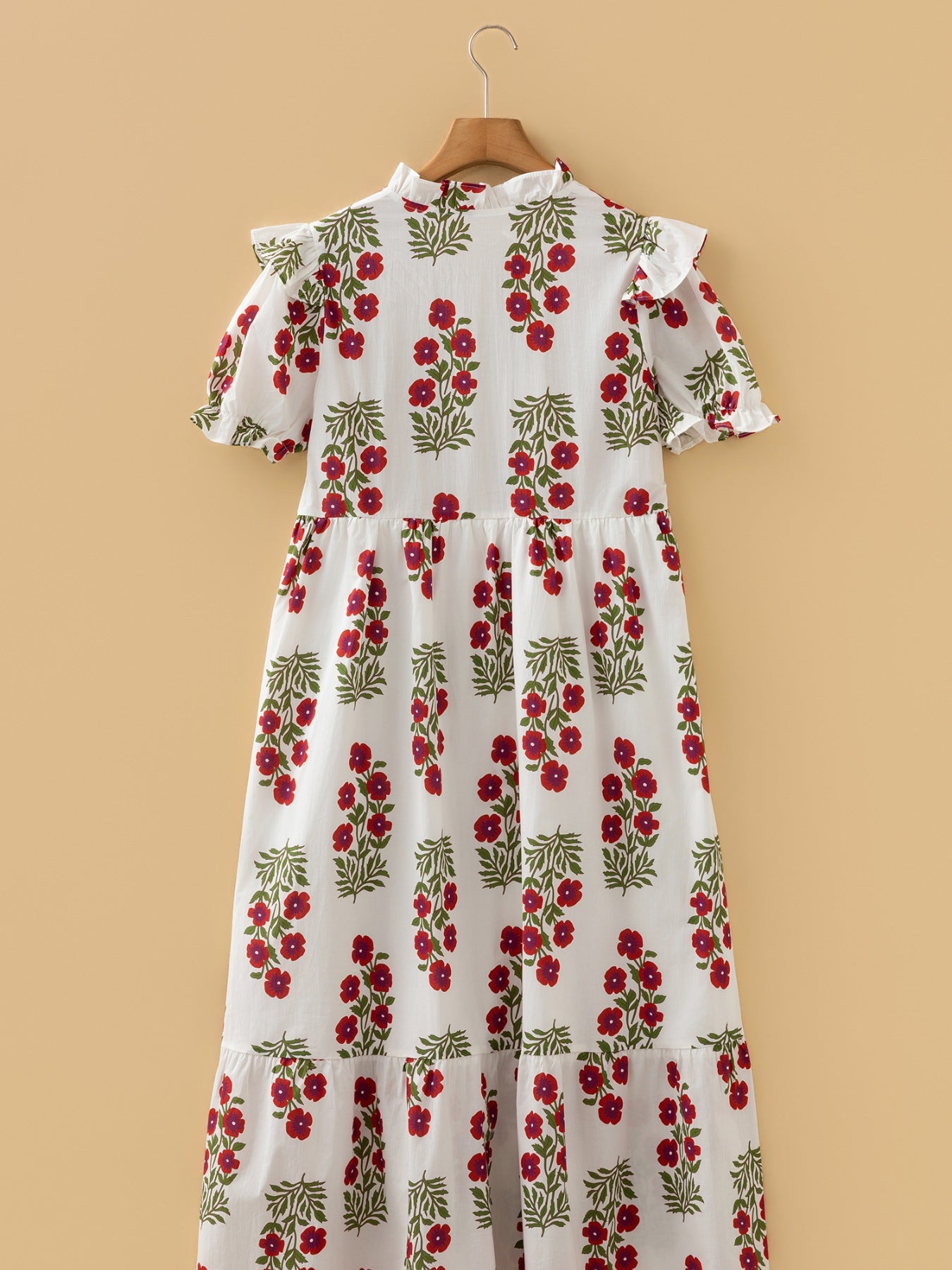 White cotton mini dress with red floral print, ruffled neckline and sleeves.
