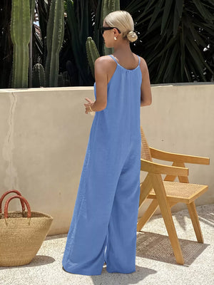 Blue tie-strap wide-leg romper with spaghetti straps and a relaxed fit.