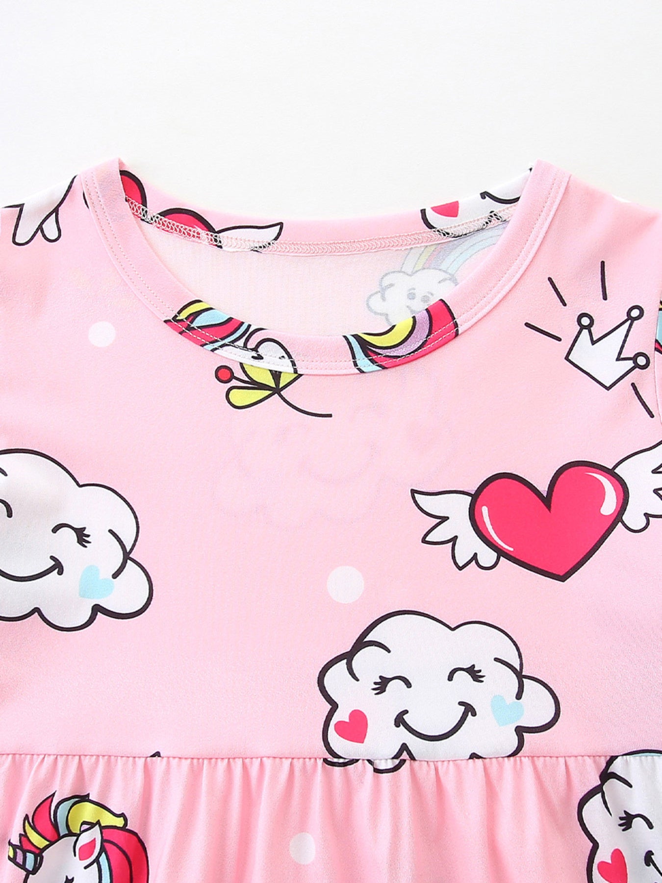 Pink toddler dress with unicorn, cloud, heart, and rainbow print.