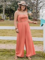 Orange wide leg jumpsuit with embroidered bodice detail and spaghetti straps.