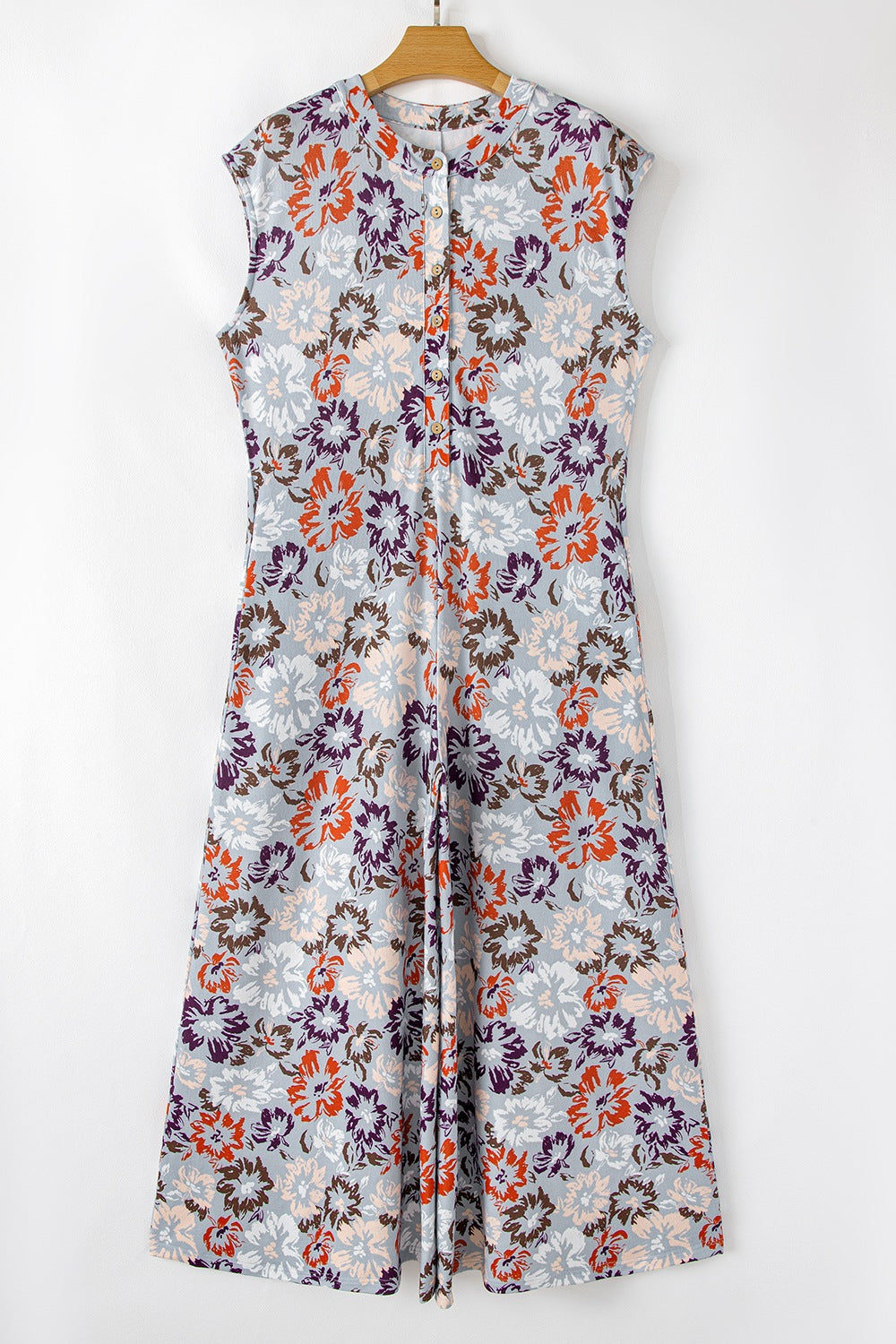 Floral cap-sleeve jumpsuit with a button-up front and wide legs.
