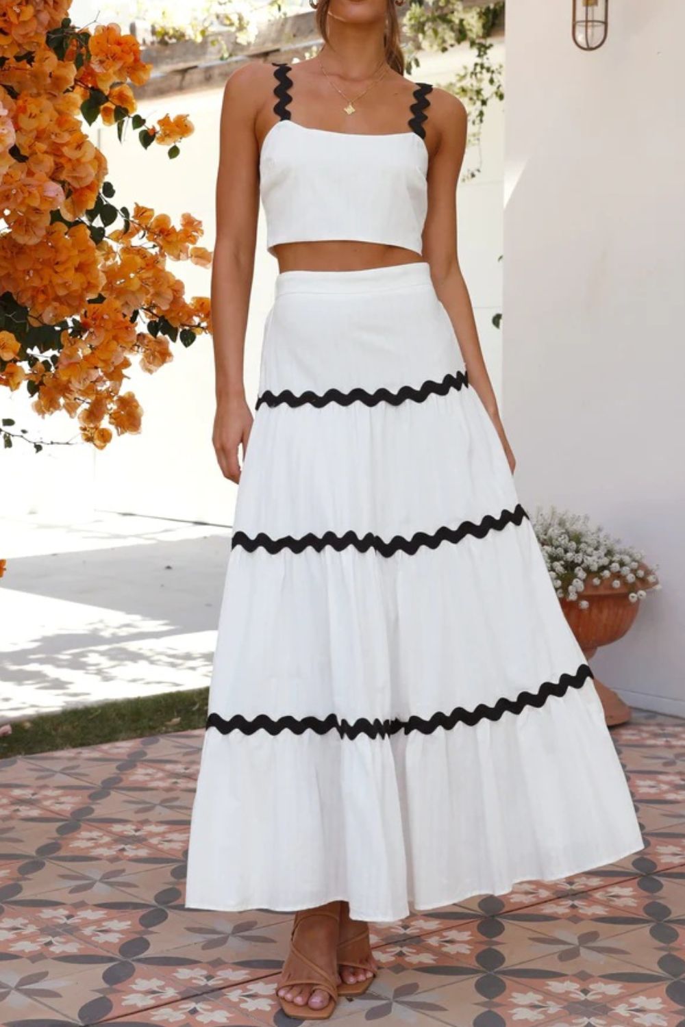 White crop top and tiered maxi skirt set with black scalloped trim detail.