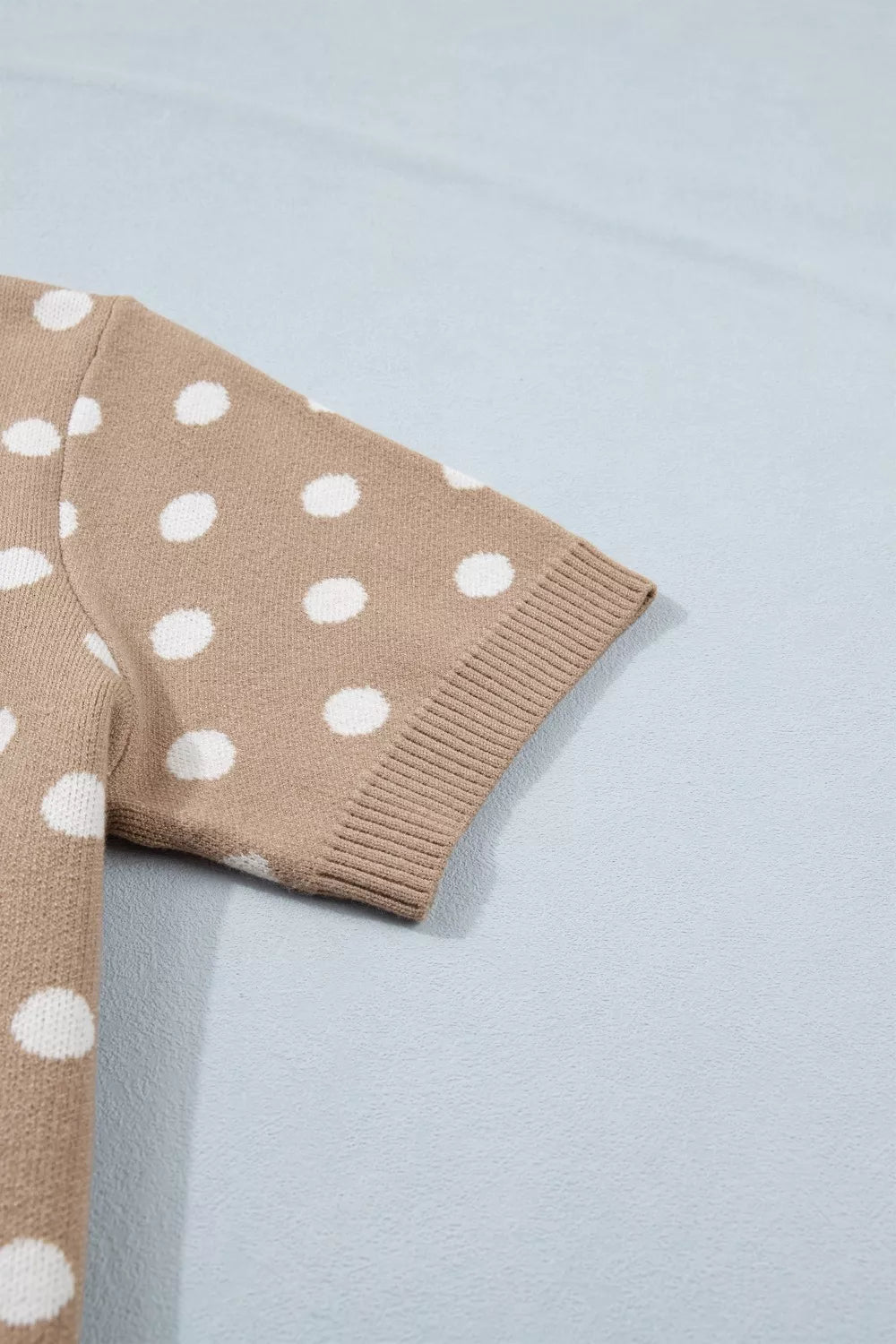 Camel polka dot short sleeve knit cardigan with ribbed cuffs.