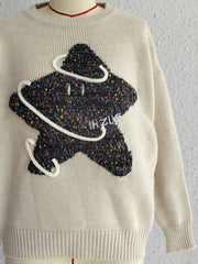 Beige knit jumper with embroidered starburst detail and white piping.