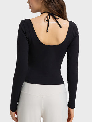 Black ribbed long sleeve active top with cutout shoulders and tie detail