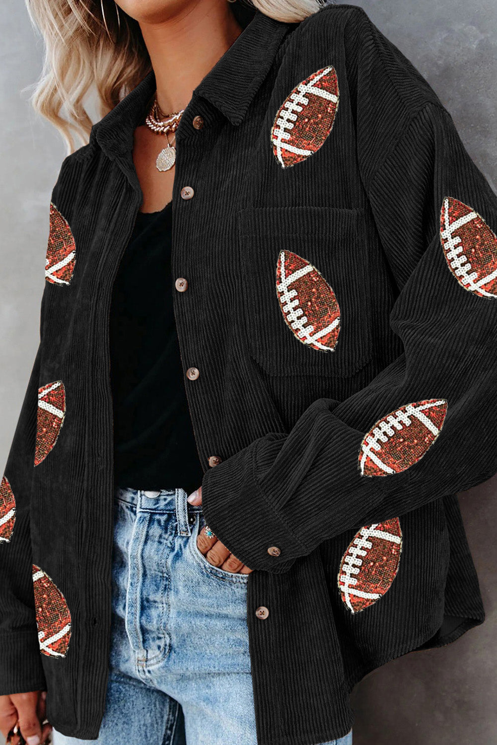 Black corduroy shirt jacket with football embellishments, button front, and chest pocket.