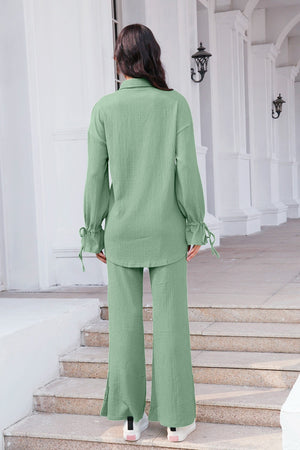 Sage green textured tie-sleeve co-ord set with wide-leg pants and split hem.