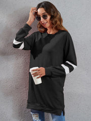 Black raglan sweatshirt dress with white varsity stripes on sleeves