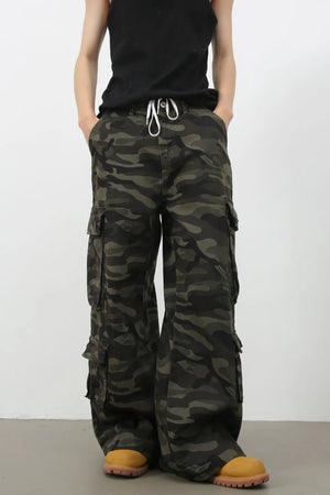 Wide-leg camo cargo pants in black with drawstring waist and multiple pockets.