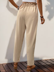 Tan linen blend trousers with gathered waistline and cuffed hems.