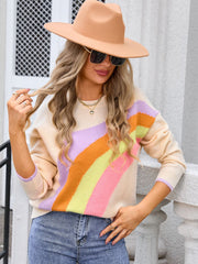 Apricot acrylic blend crewneck sweater with diagonal rainbow stripes and lilac cuffs.