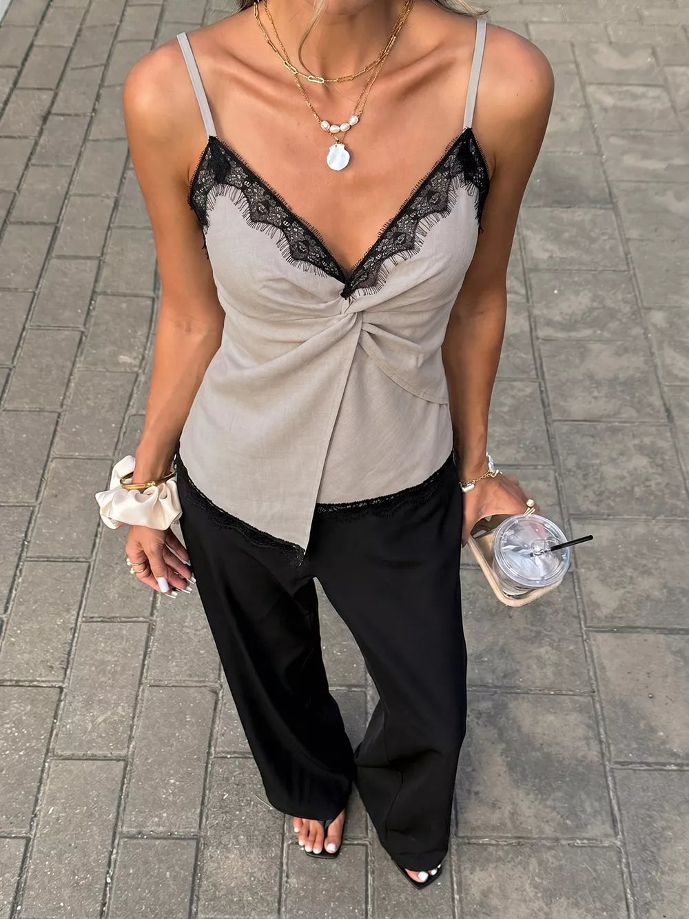 Luxe cami top in beige with black lace trim and twisted detail.