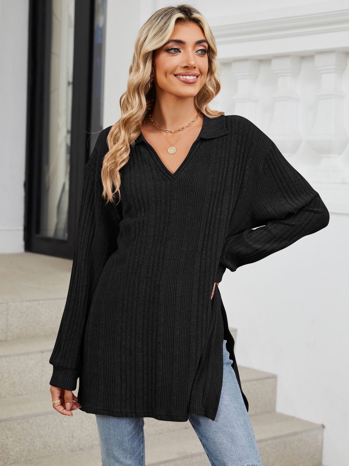 Black ribbed knit collared tunic top with long sleeves and slit hem