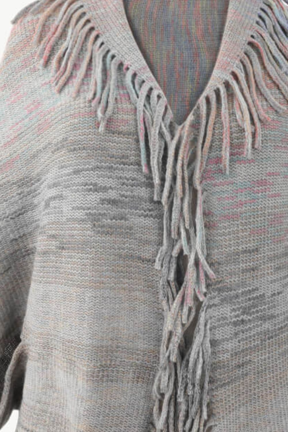 Textured stripe fringe cape in gray with subtle pink and blue threads, acrylic knit.