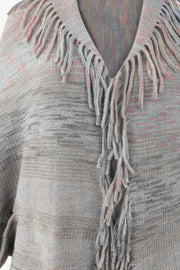 Textured stripe fringe cape in gray with subtle pink and blue threads, acrylic knit.