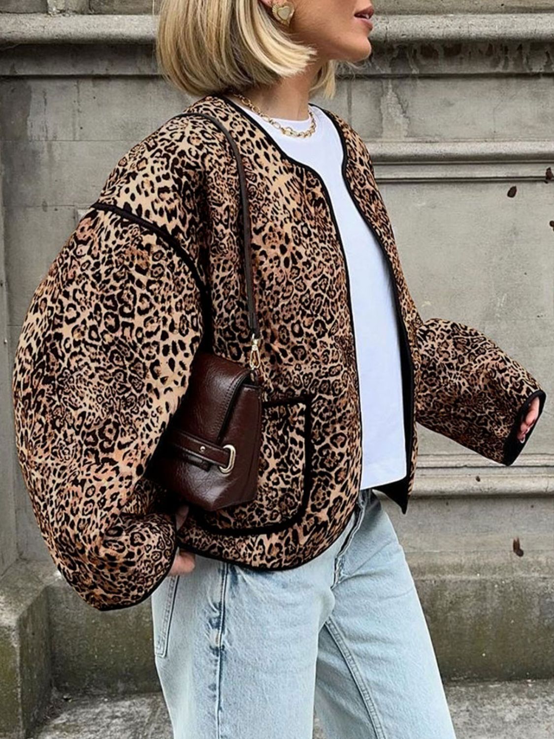 Leopard print boxy jacket with black trim and pockets, worn open over a white tee.