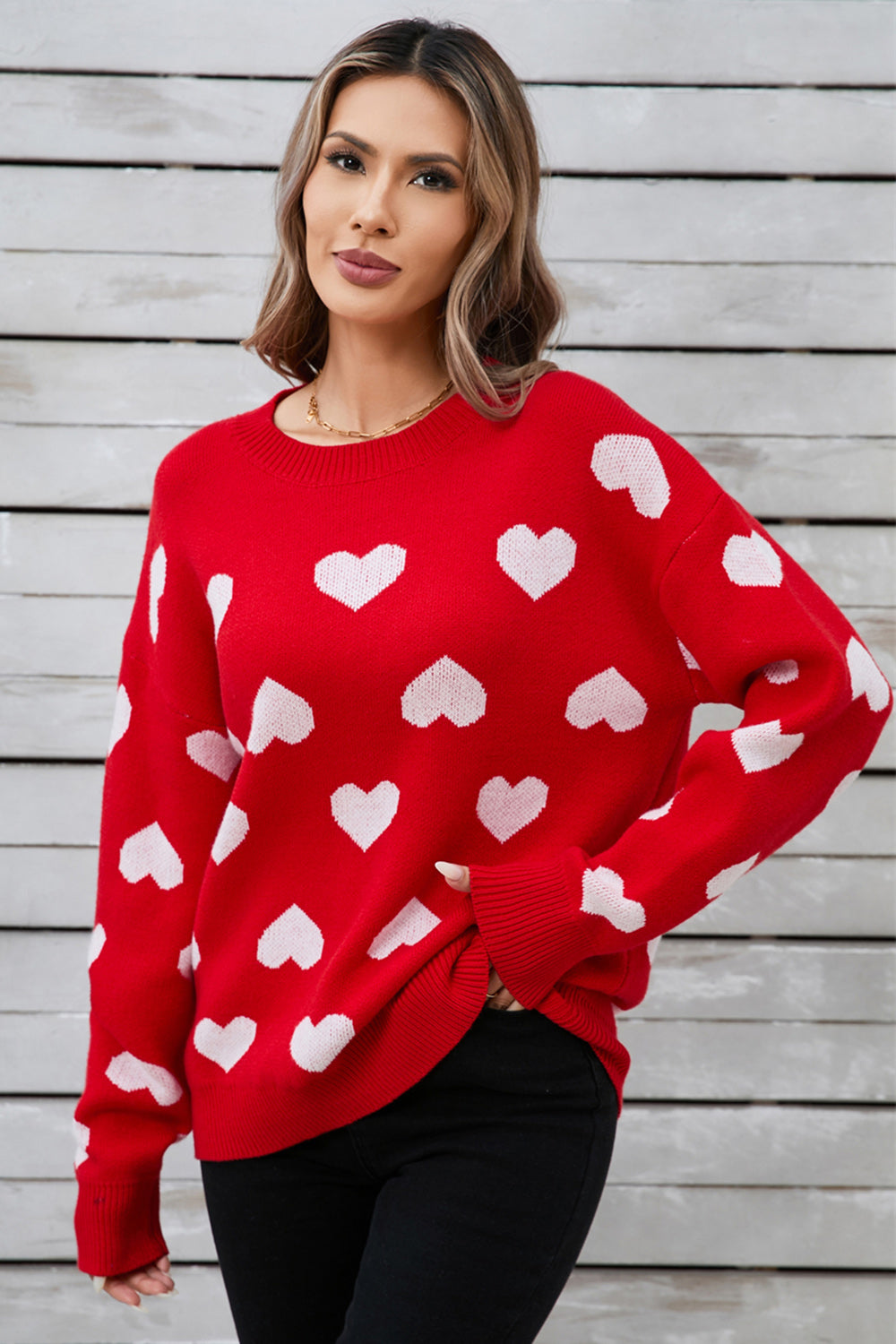 Red acrylic sweater with white heart intarsia pattern, crew neck, long sleeves.