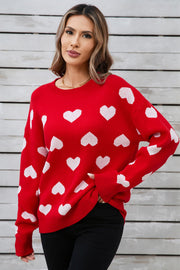 Red acrylic sweater with white heart intarsia pattern, crew neck, long sleeves.