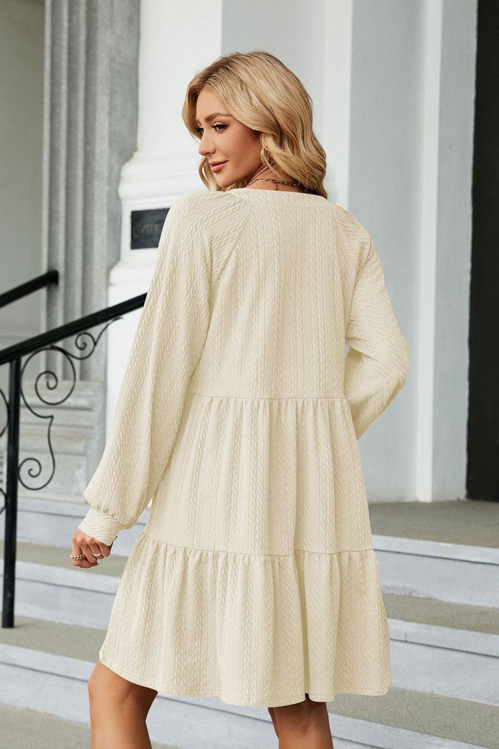 Cream textured babydoll mini dress with voluminous sleeves and tiered skirt