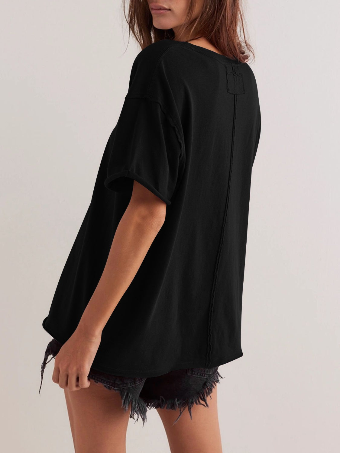 Black oversized cotton tee with seam details and short sleeves