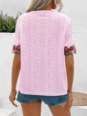 Blush pink peasant blouse with eyelet fabric and floral embroidered sleeves.