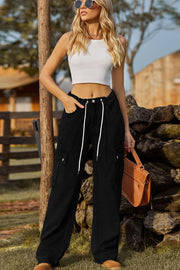 Black denim cargo pants with drawstring waist and utility pockets.