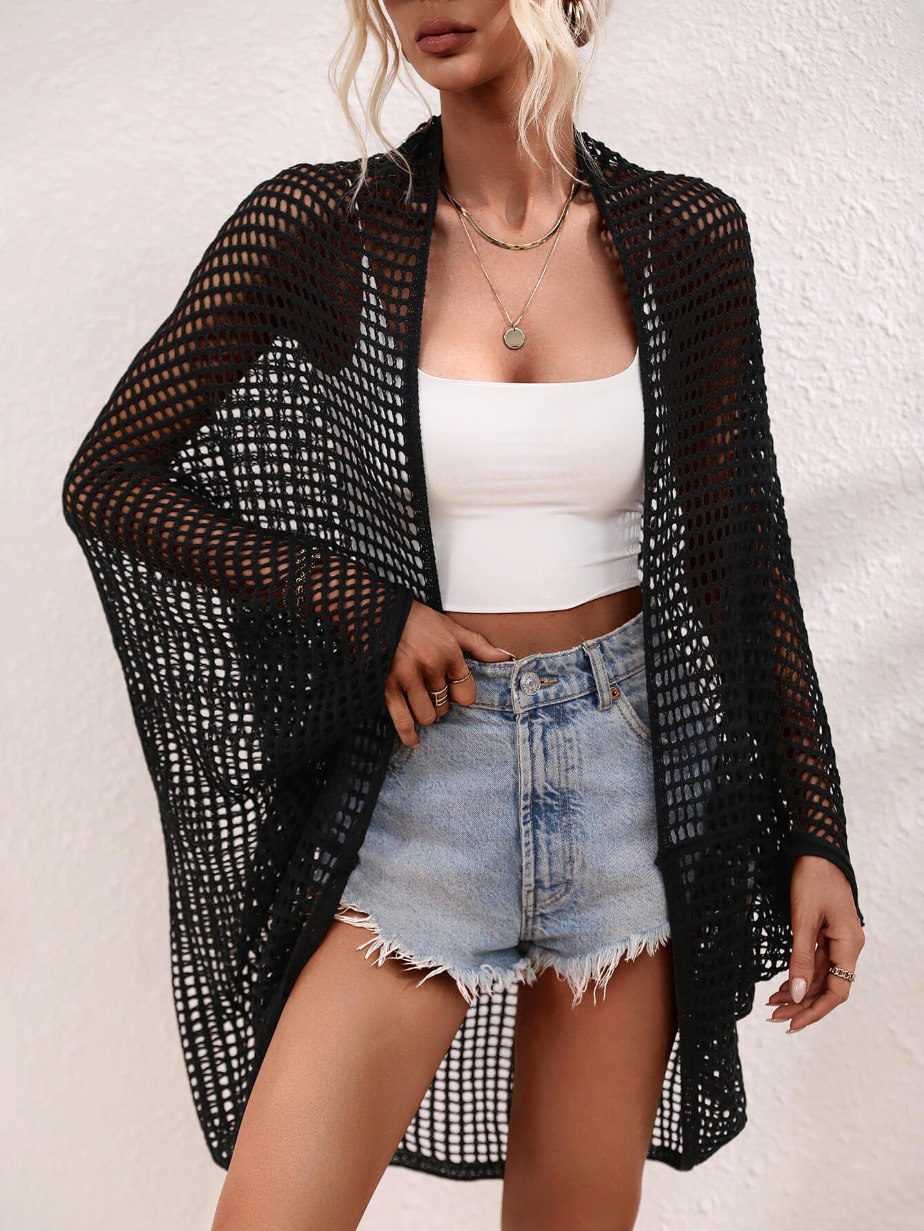 Black open-weave kimono duster with batwing sleeves and breathable acrylic fabric.