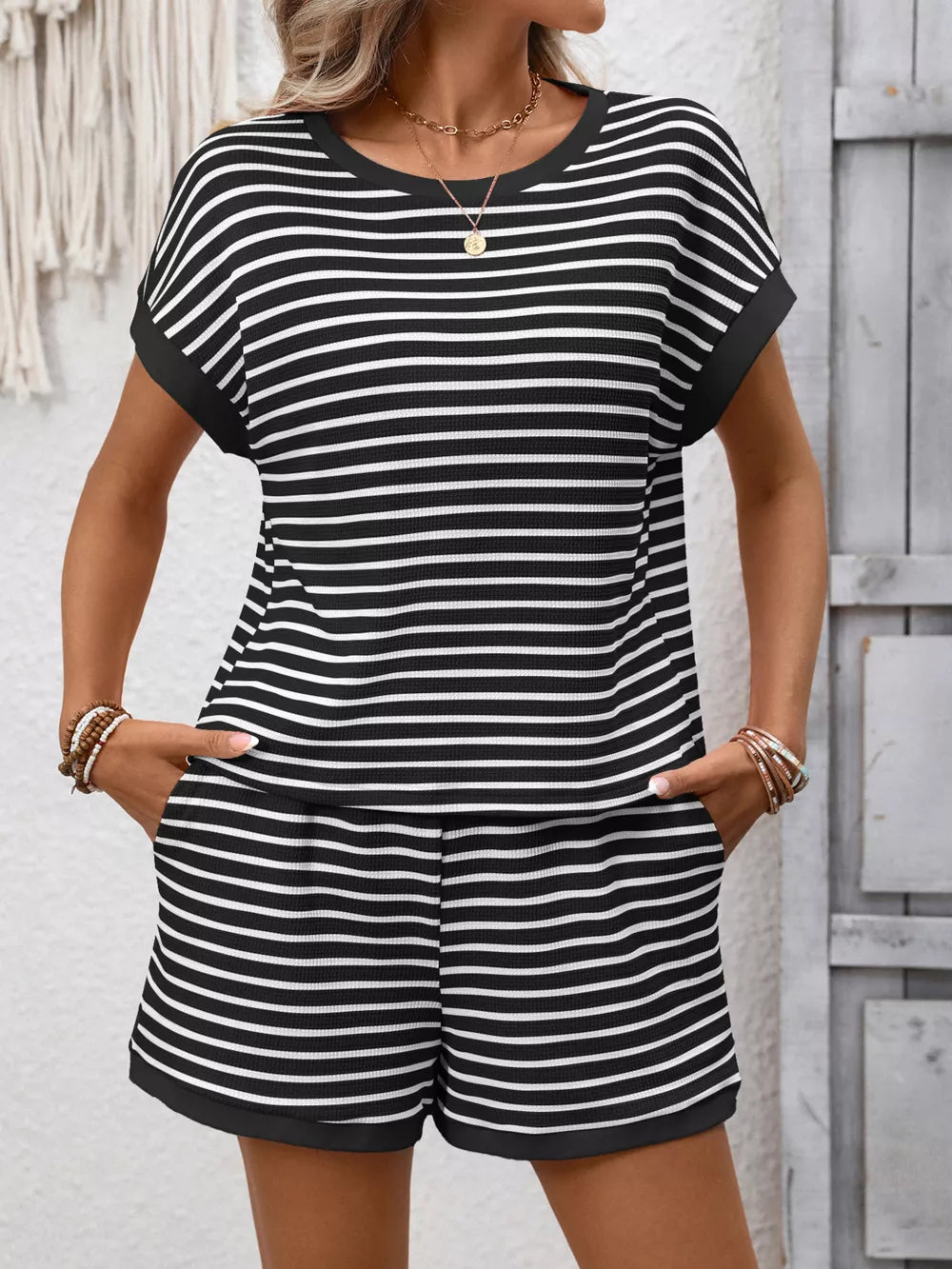 Black and white striped loungewear set with pockets, featuring a crew neck top and shorts.