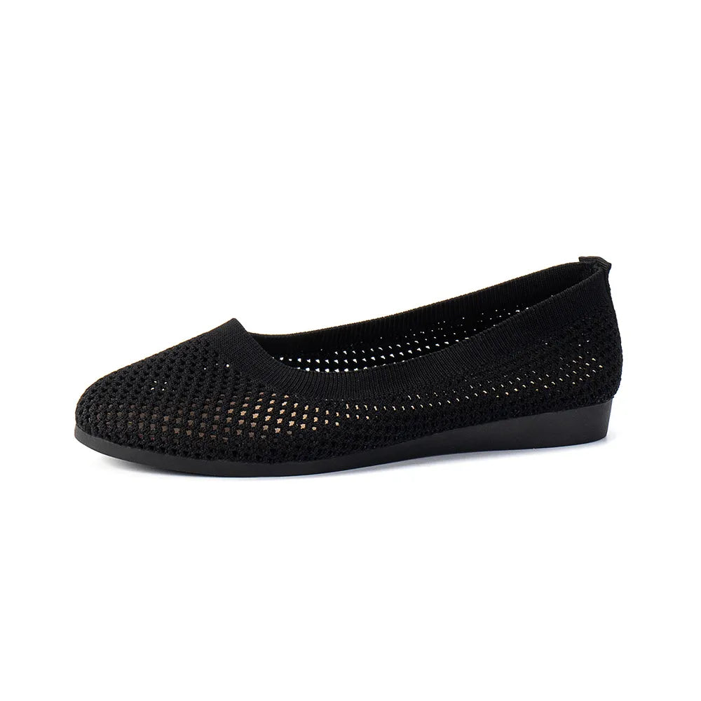 Black breathable knit ballet flats with a perforated texture.